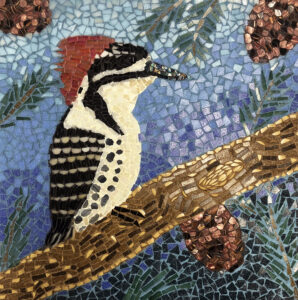 Mosaic of a Woodpecker with a white chest, black wings and a red crests on its head sitting on a branch. The background is a winter blue.